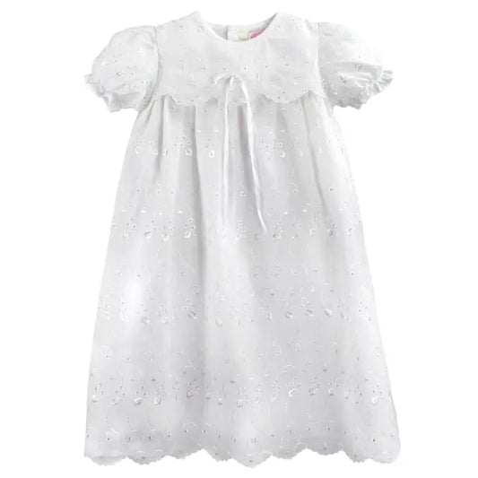 White baby dress with lace details on a white background