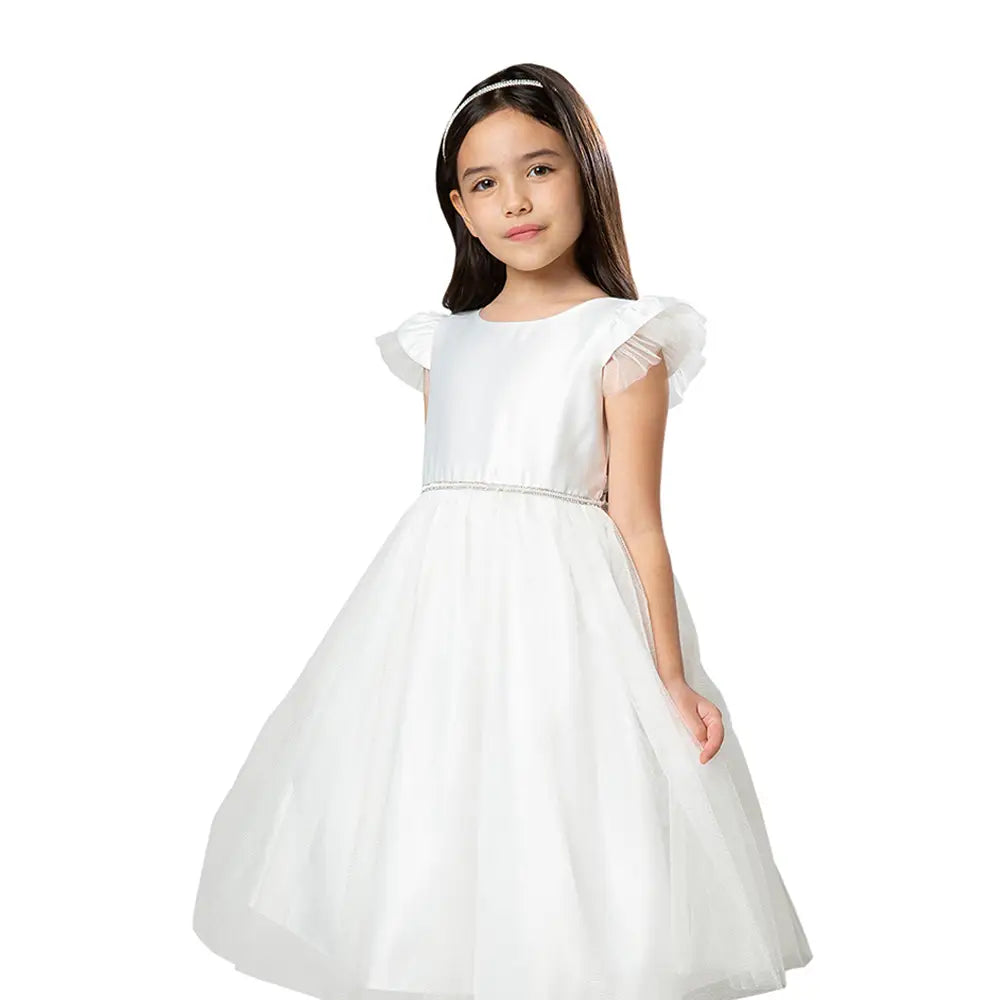 Young girl wearing a white dress with sheer sleeves on a white background