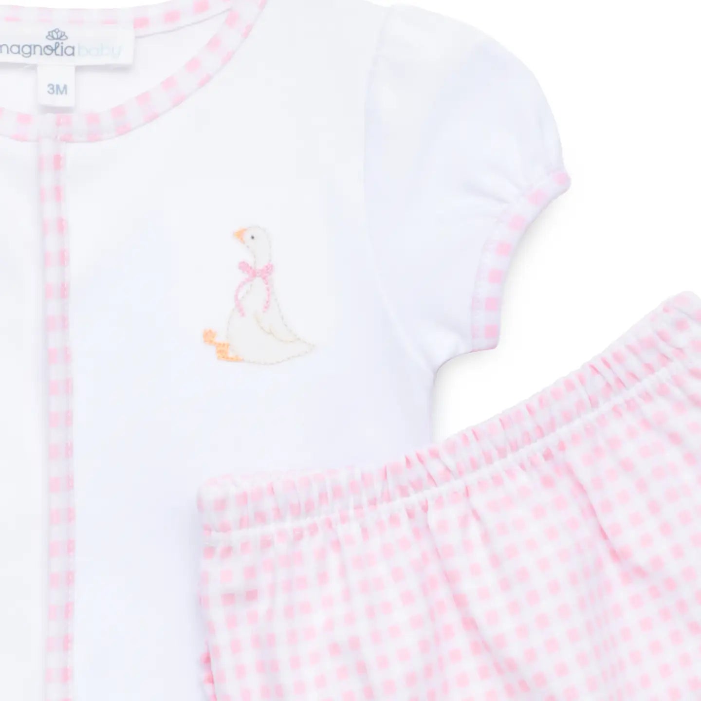 Baby outfit with white shirt and pink checkered pants on a white background