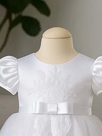 White dress with puff sleeves on a mannequin against a neutral background