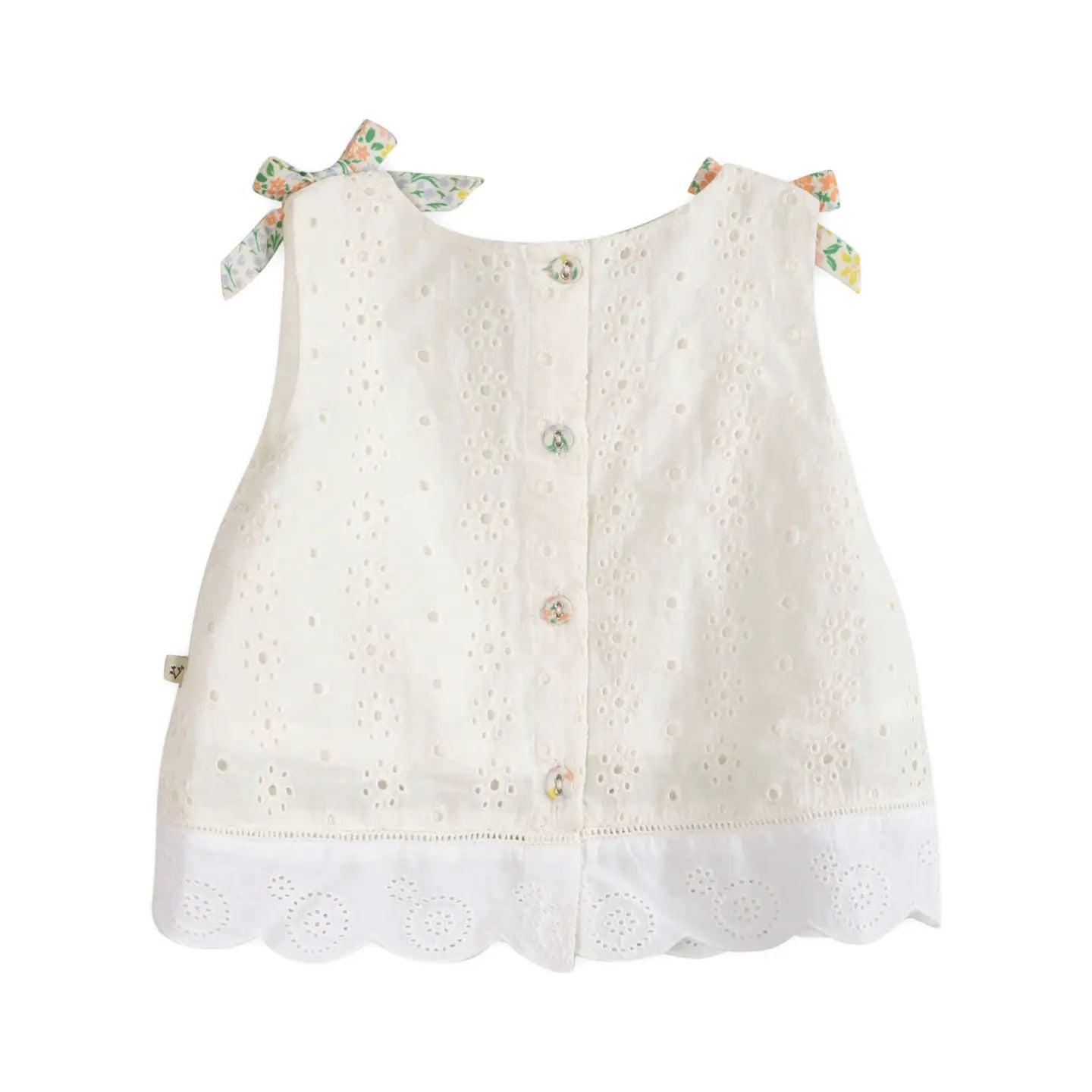 White lace top with decorative buttons on a white background