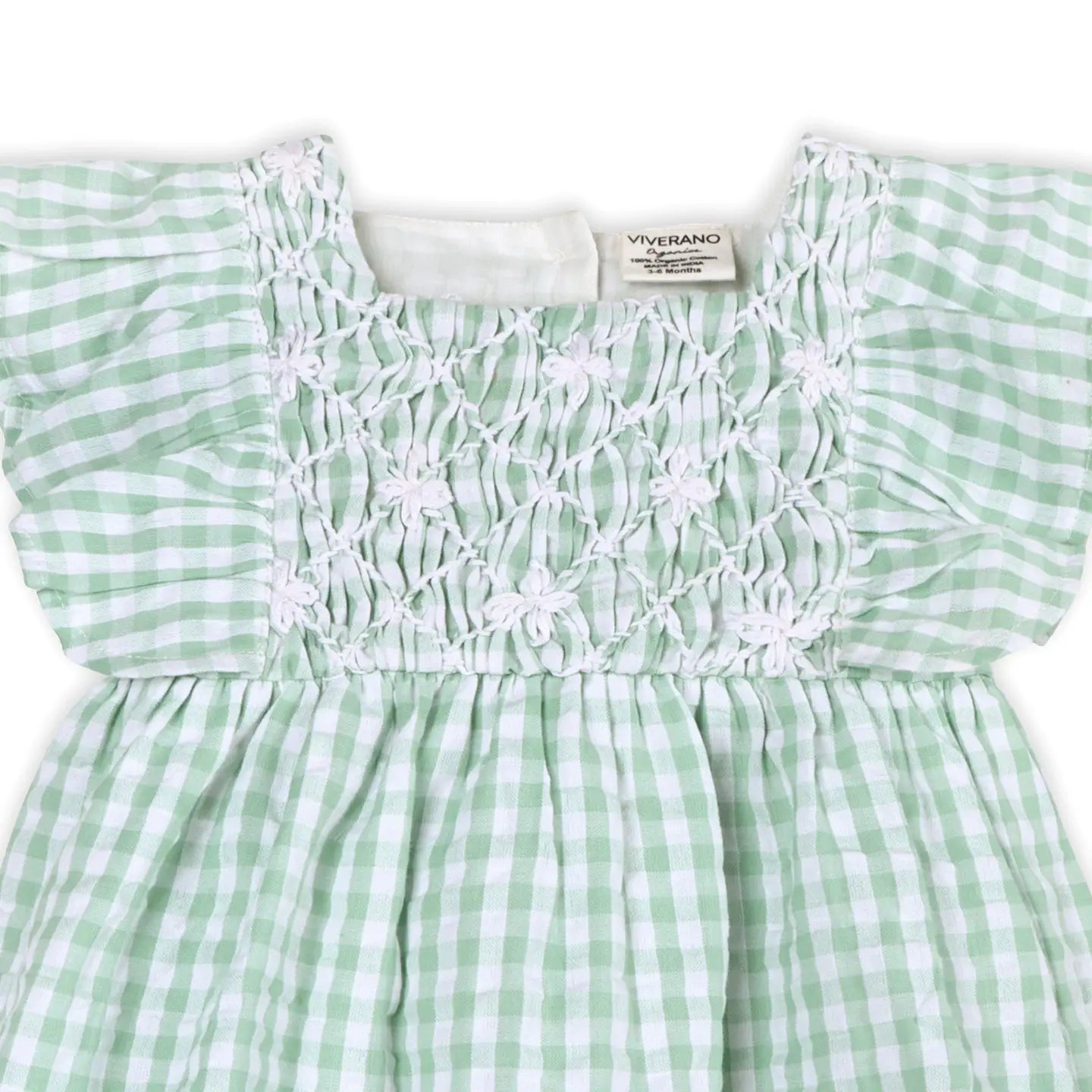 Green and white checkered dress with smocked bodice on a white background